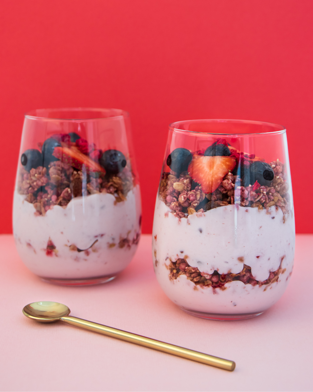 Layers of Greek yogurt, granola, sliced bananas, and a dash of cinnamon